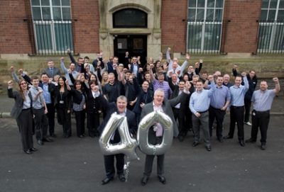 Pennine Telecom 40th anniversary staff photo cheering w