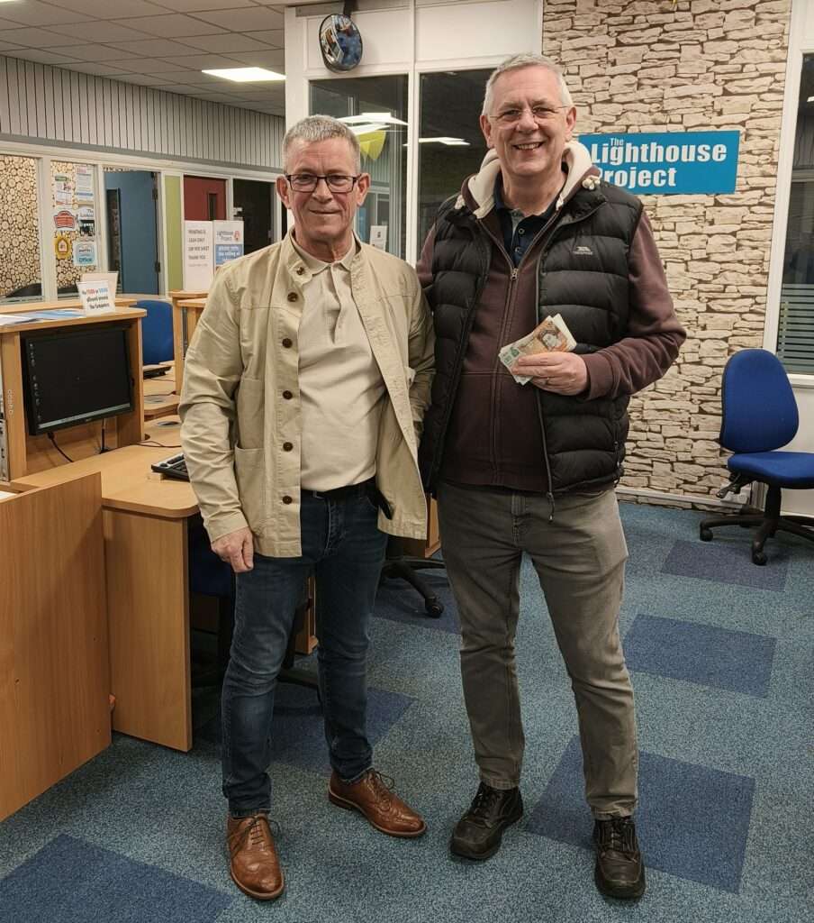 Carl receiving a donation for the Lighthouse Project