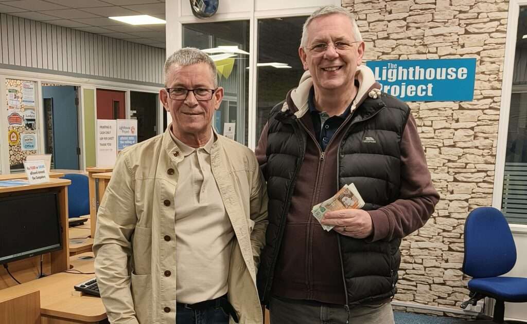Carl receiving donation for the Lighthouse Project
