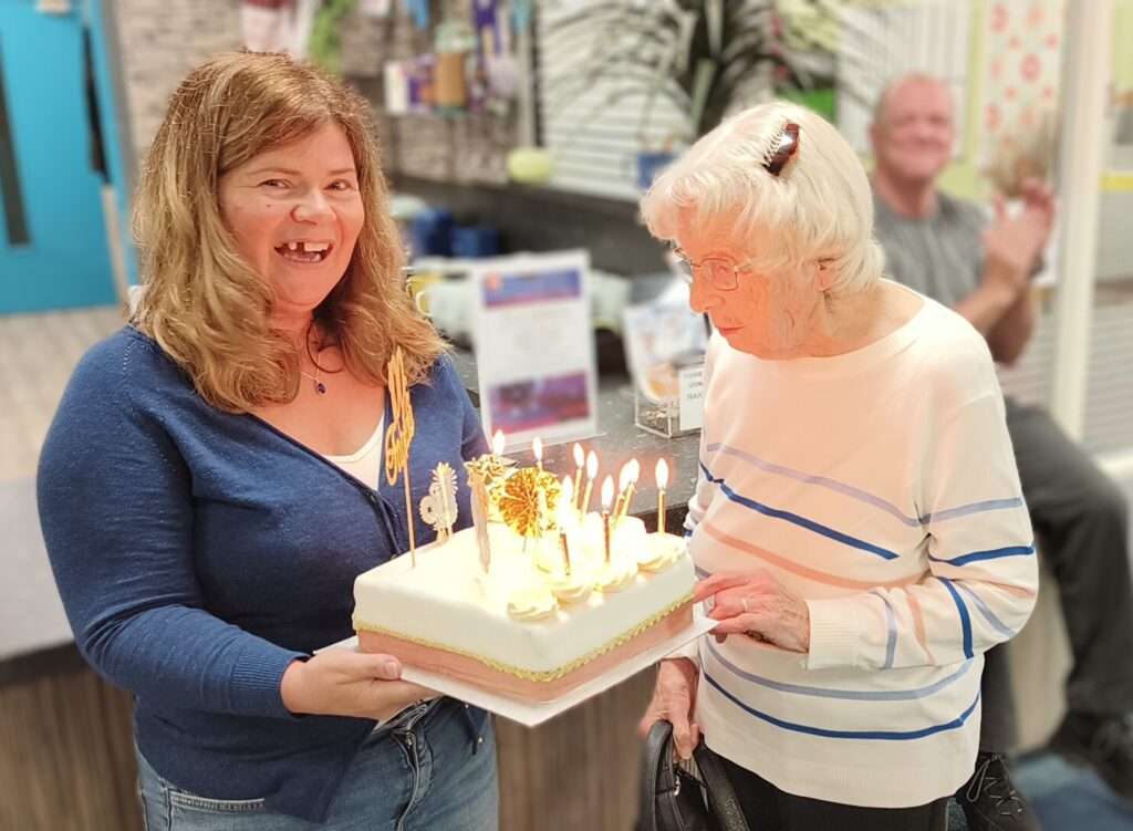 Eva and Cath holding 100th year birthday cake