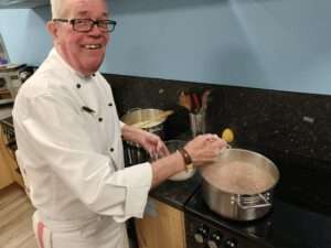 Chef Noel Goulding cooking in the Lighthouse Project kitchen